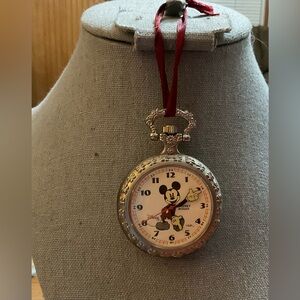 Hallmark Keepsake ornament: a pocket watch of Mickey Mouse medal with red ribbon
